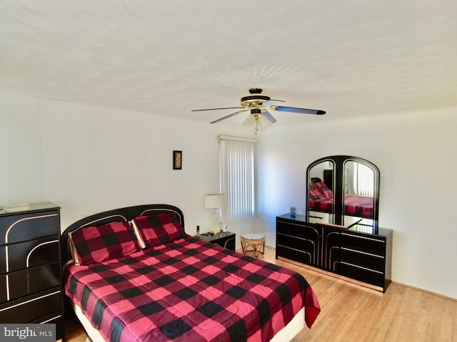 bedroom with ceiling fan and light hardwood / wood-style floors