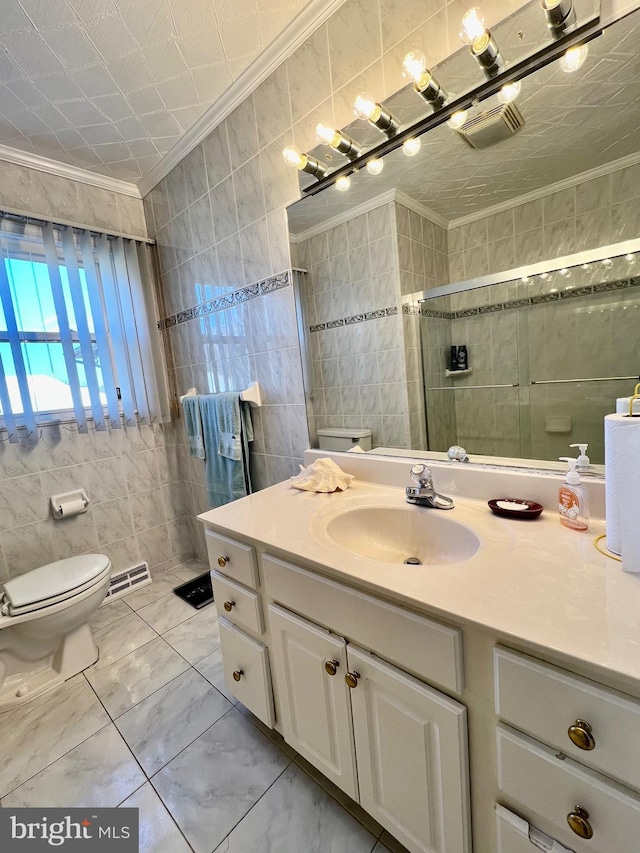 bathroom featuring tile flooring, tile walls, toilet, vanity, and crown molding