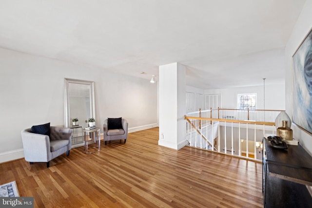 sitting room featuring light hardwood / wood-style flooring and an inviting chandelier