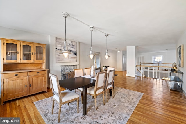 dining space with an inviting chandelier and light hardwood / wood-style floors