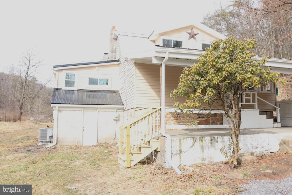 back of property featuring central AC