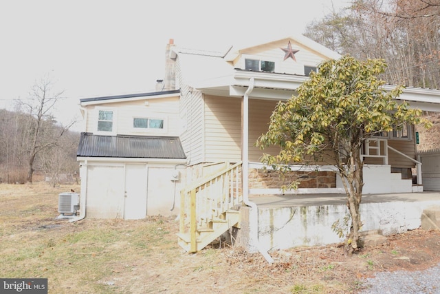 back of property featuring central AC