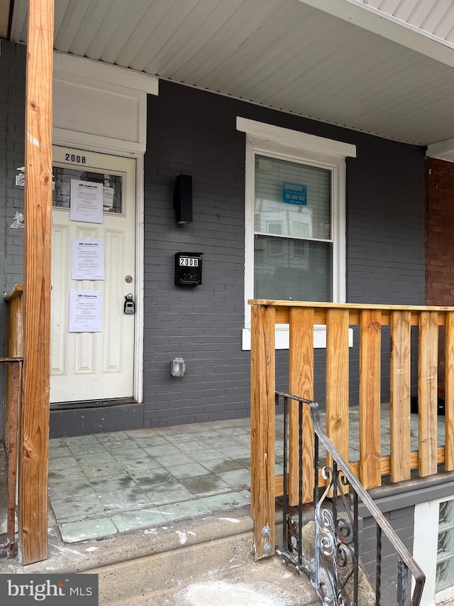 view of exterior entry featuring a porch