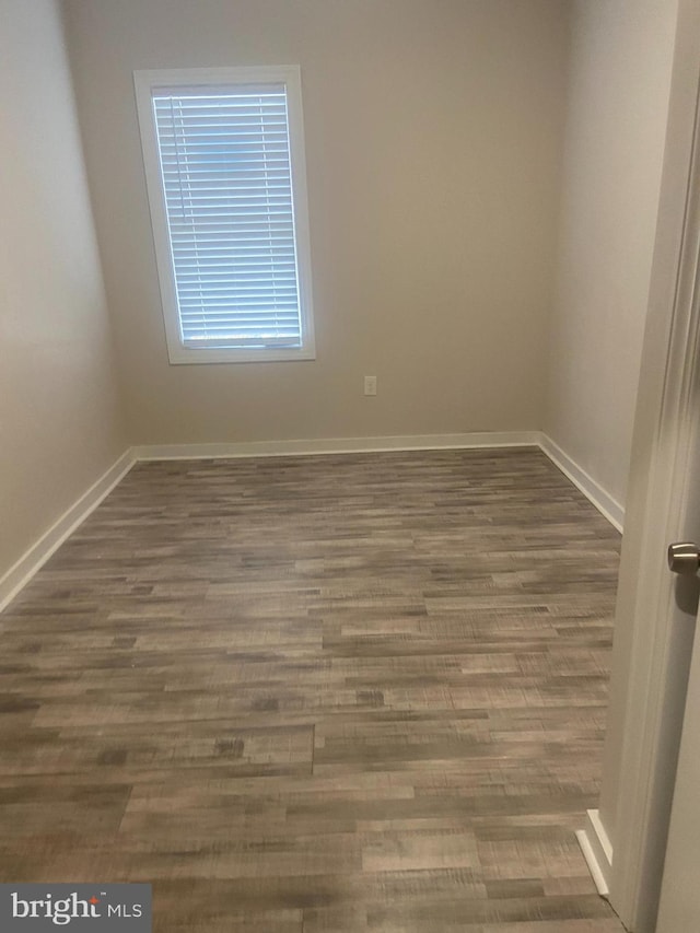 empty room with dark wood-type flooring