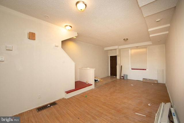 empty room featuring radiator heating unit and wood-type flooring