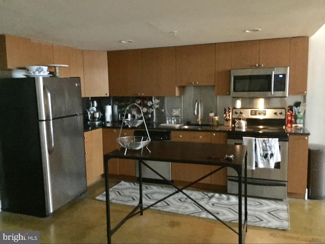 kitchen with a breakfast bar area, tasteful backsplash, appliances with stainless steel finishes, and sink