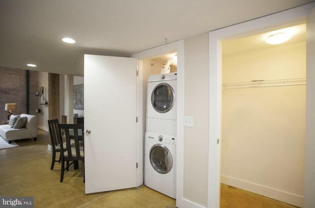 laundry area with stacked washer / drying machine