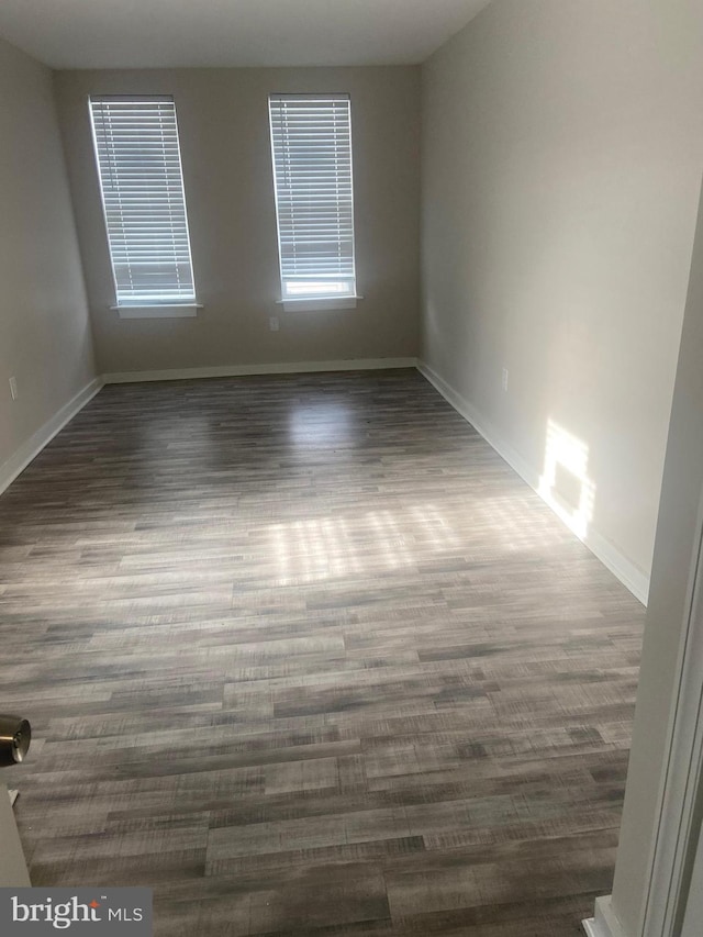 spare room featuring dark hardwood / wood-style flooring