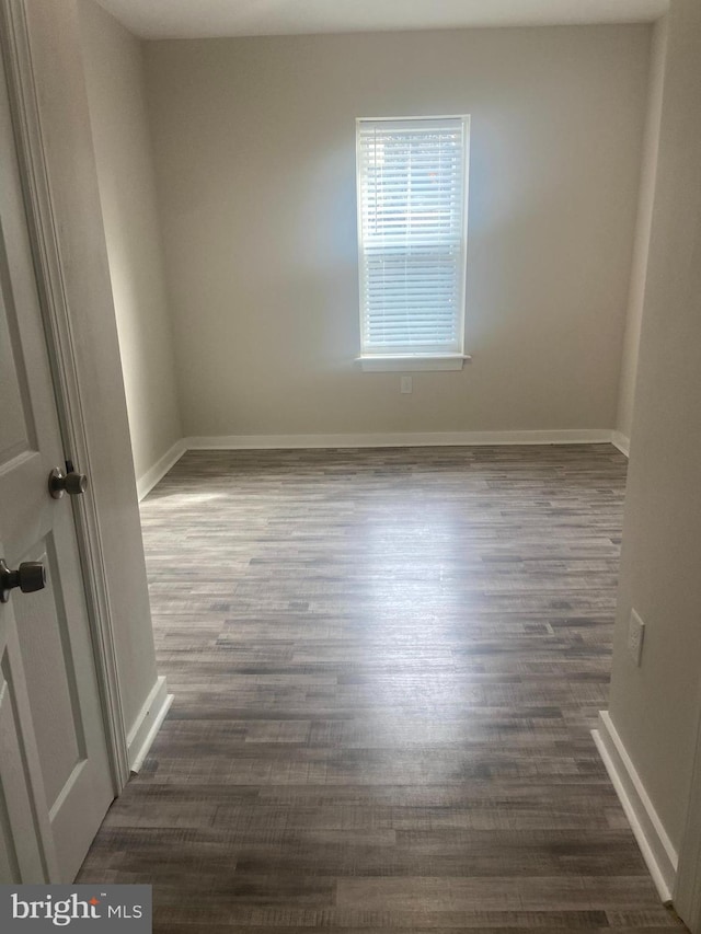 unfurnished room featuring dark hardwood / wood-style floors