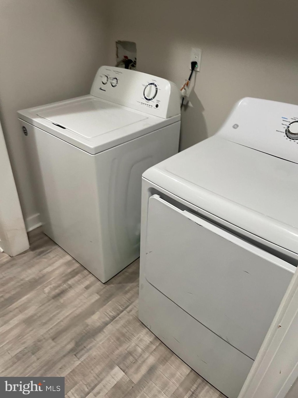 washroom featuring washer hookup, light hardwood / wood-style flooring, and washer and dryer