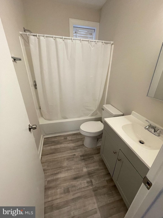 full bathroom with shower / bath combination with curtain, vanity, wood-type flooring, and toilet