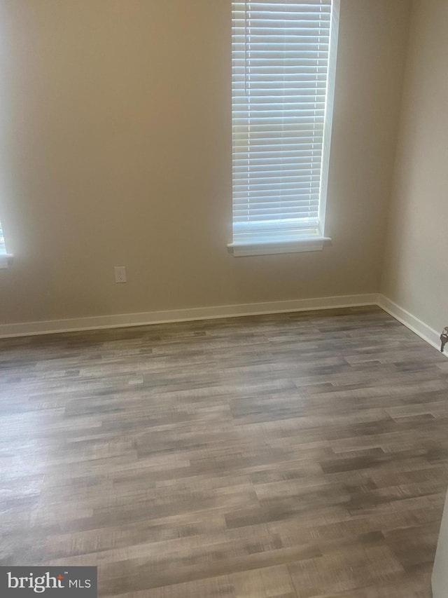 unfurnished room featuring hardwood / wood-style floors