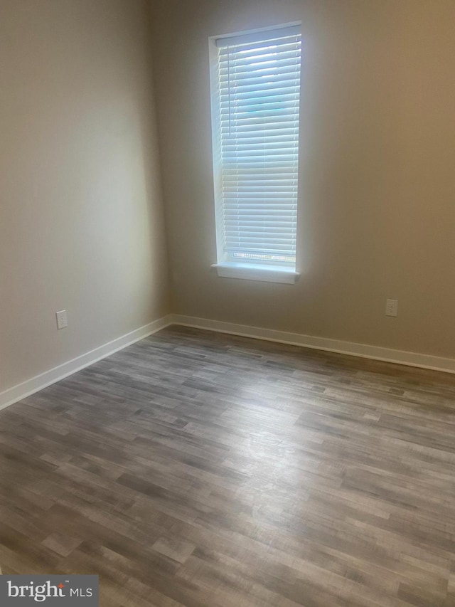 spare room featuring dark hardwood / wood-style floors