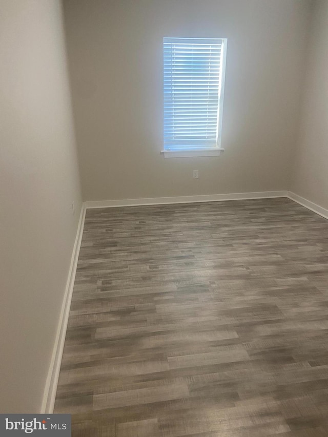 empty room with hardwood / wood-style floors