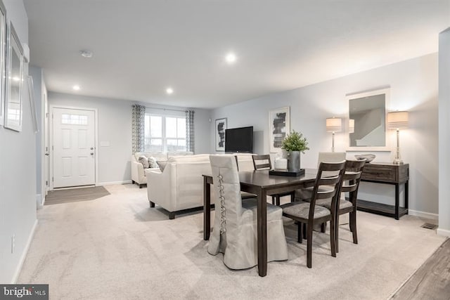 dining room with light colored carpet