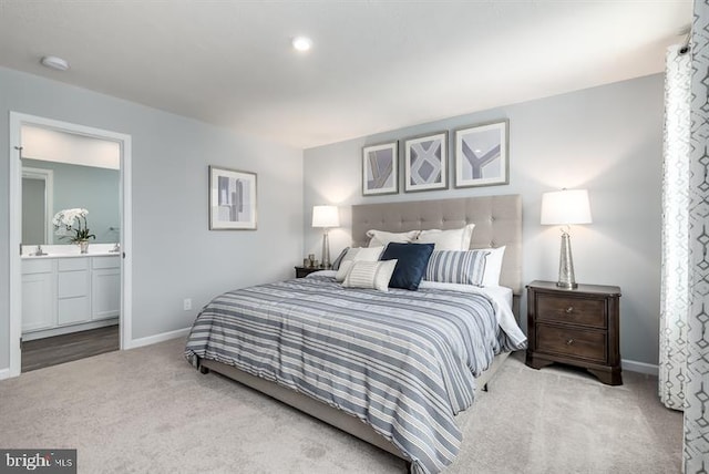 carpeted bedroom featuring connected bathroom