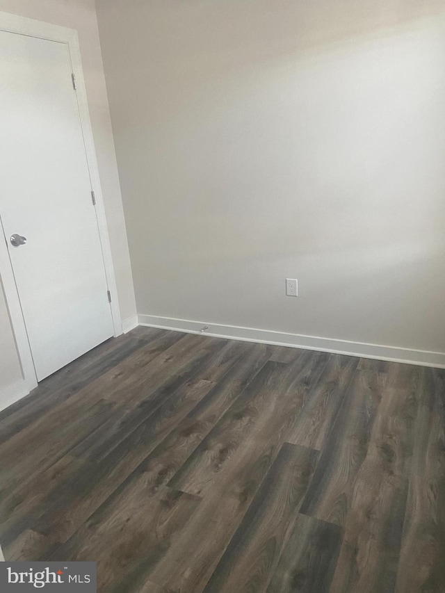 unfurnished room featuring dark hardwood / wood-style floors