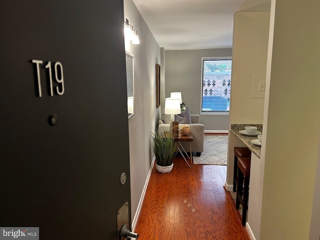 hall with dark hardwood / wood-style flooring