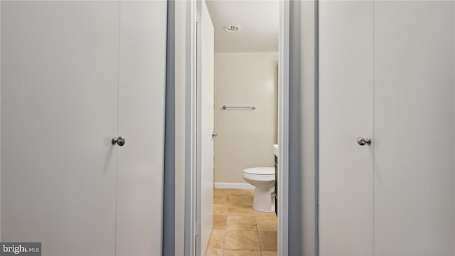 bathroom featuring tile floors and toilet