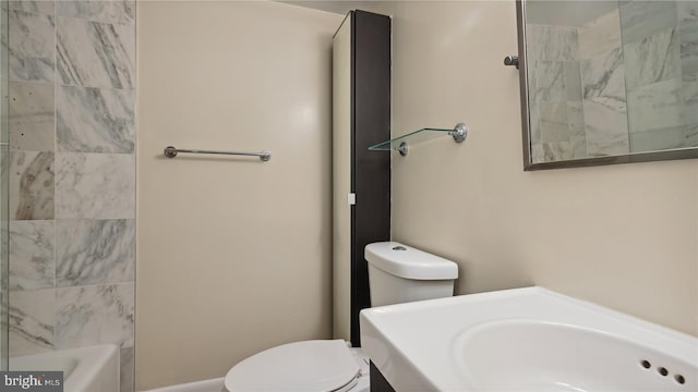 full bathroom featuring vanity, tiled shower / bath combo, and toilet