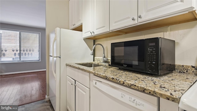 kitchen featuring white appliances, sink, white cabinetry, and dark hardwood / wood-style flooring