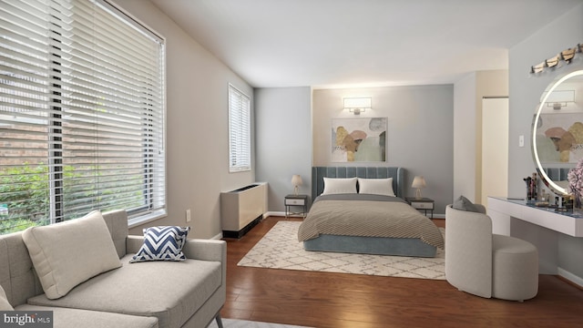 bedroom featuring dark hardwood / wood-style flooring and radiator