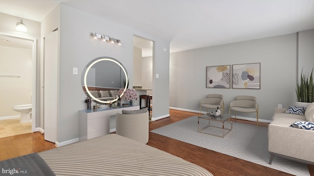 bedroom featuring light tile floors and ensuite bathroom