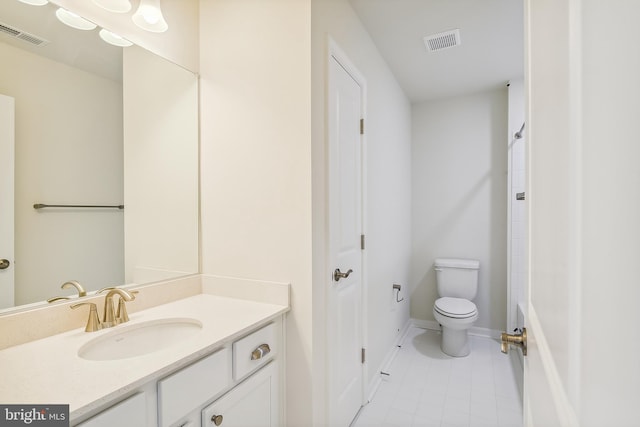 bathroom featuring tile floors, oversized vanity, and toilet