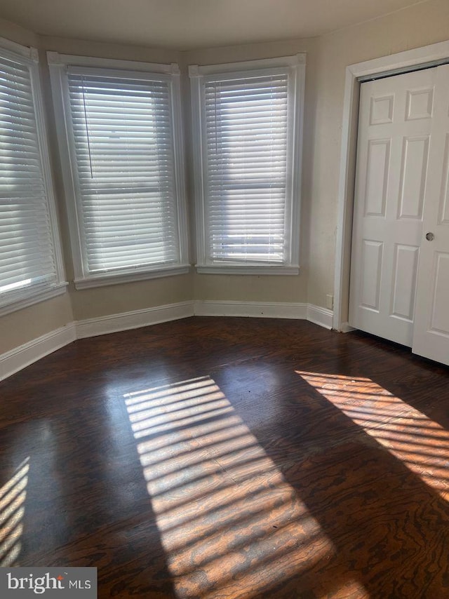 unfurnished bedroom featuring dark hardwood / wood-style flooring