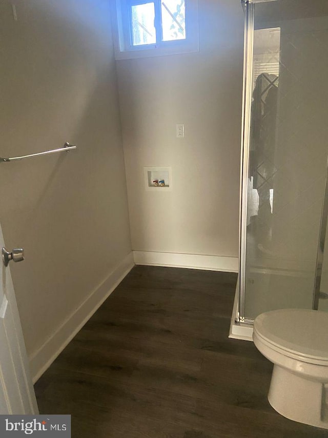 bathroom with toilet and hardwood / wood-style flooring