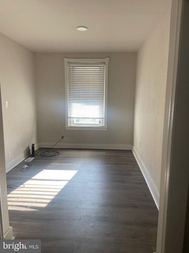 empty room with dark hardwood / wood-style floors