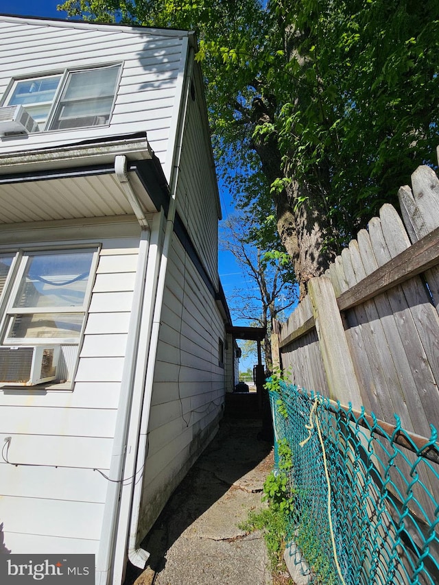 view of side of home featuring cooling unit