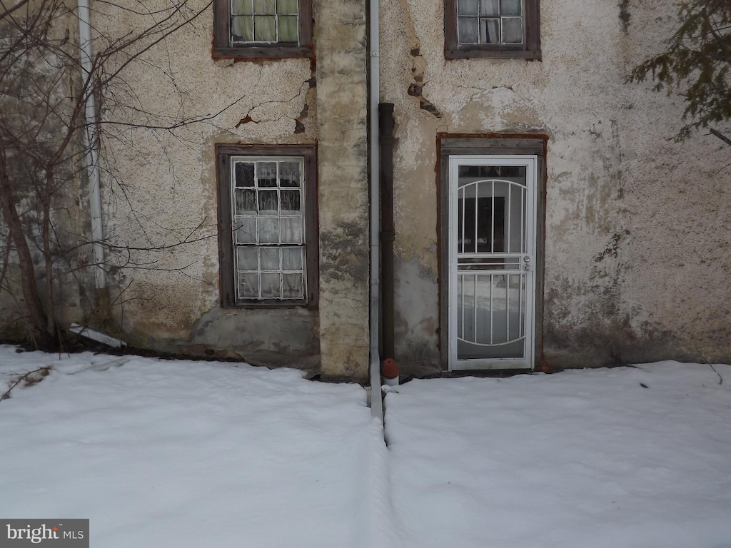 view of snow covered property entrance