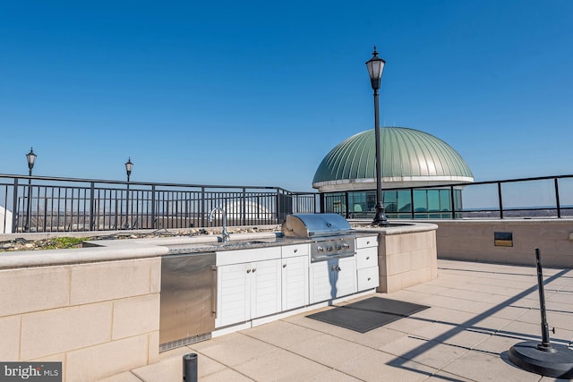 view of terrace featuring sink, area for grilling, and an outdoor kitchen