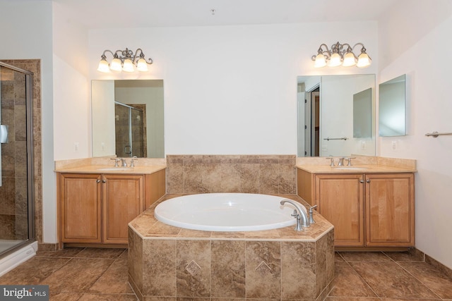 bathroom with large vanity, tile floors, and separate shower and tub