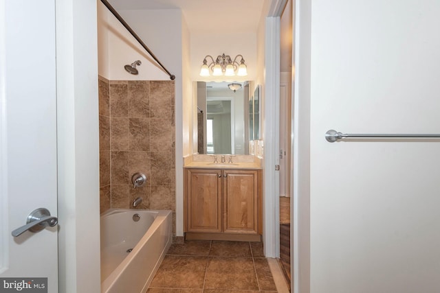 bathroom featuring tiled shower / bath, tile floors, and vanity