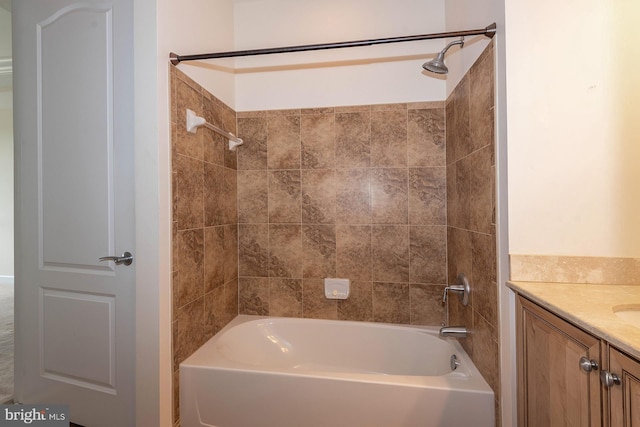 bathroom featuring tiled shower / bath combo and vanity