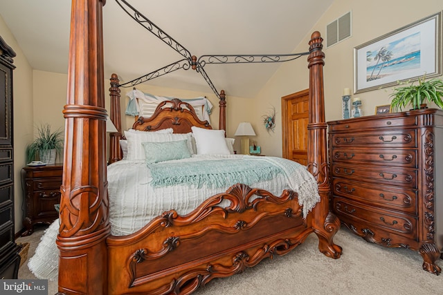 bedroom with carpet flooring and vaulted ceiling