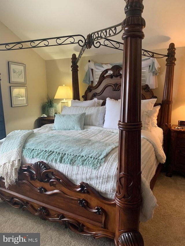 carpeted bedroom with vaulted ceiling