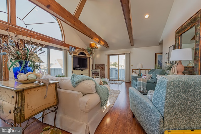 living room featuring dark hardwood / wood-style flooring, high vaulted ceiling, and beam ceiling