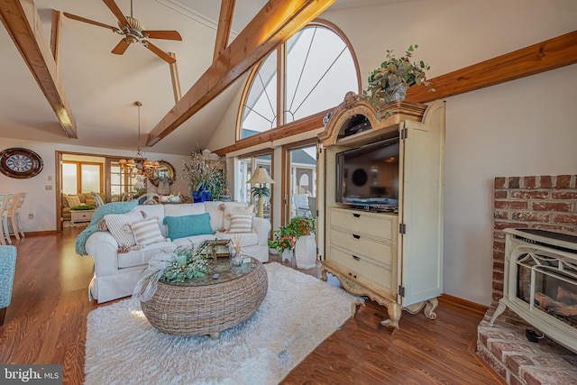 living room with beam ceiling, ceiling fan, hardwood / wood-style flooring, and a fireplace