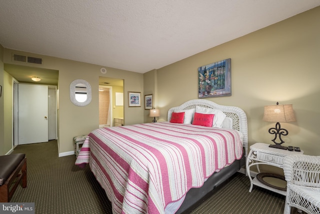 carpeted bedroom with a textured ceiling