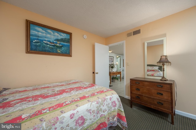 carpeted bedroom featuring a textured ceiling