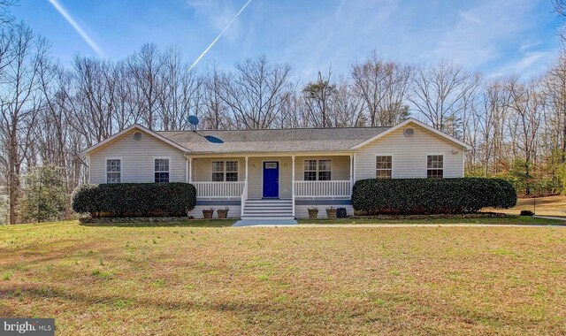 ranch-style house with a front yard and covered porch