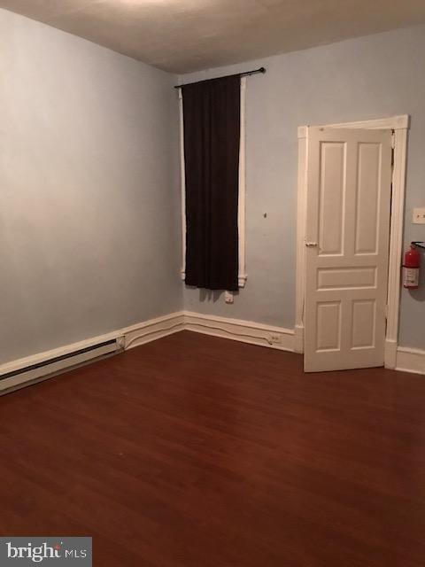 spare room featuring dark hardwood / wood-style floors