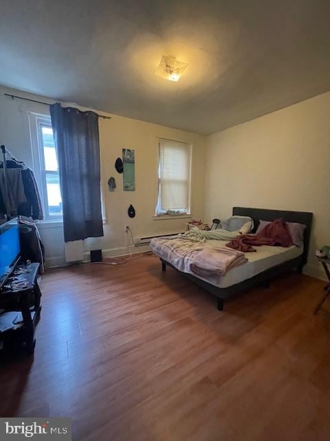 bedroom with dark hardwood / wood-style floors