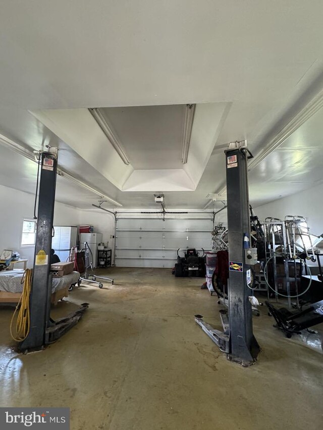 garage featuring a garage door opener and fridge