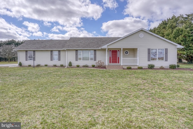 ranch-style home with a front yard and covered porch