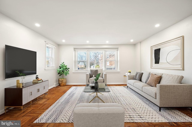 living room with a healthy amount of sunlight and parquet floors