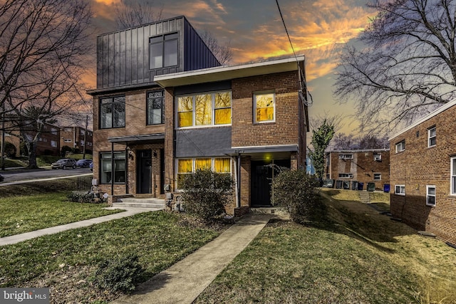 modern home featuring a yard